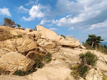 Rock formations on landscape against sky