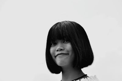 Portrait of smiling woman against white background