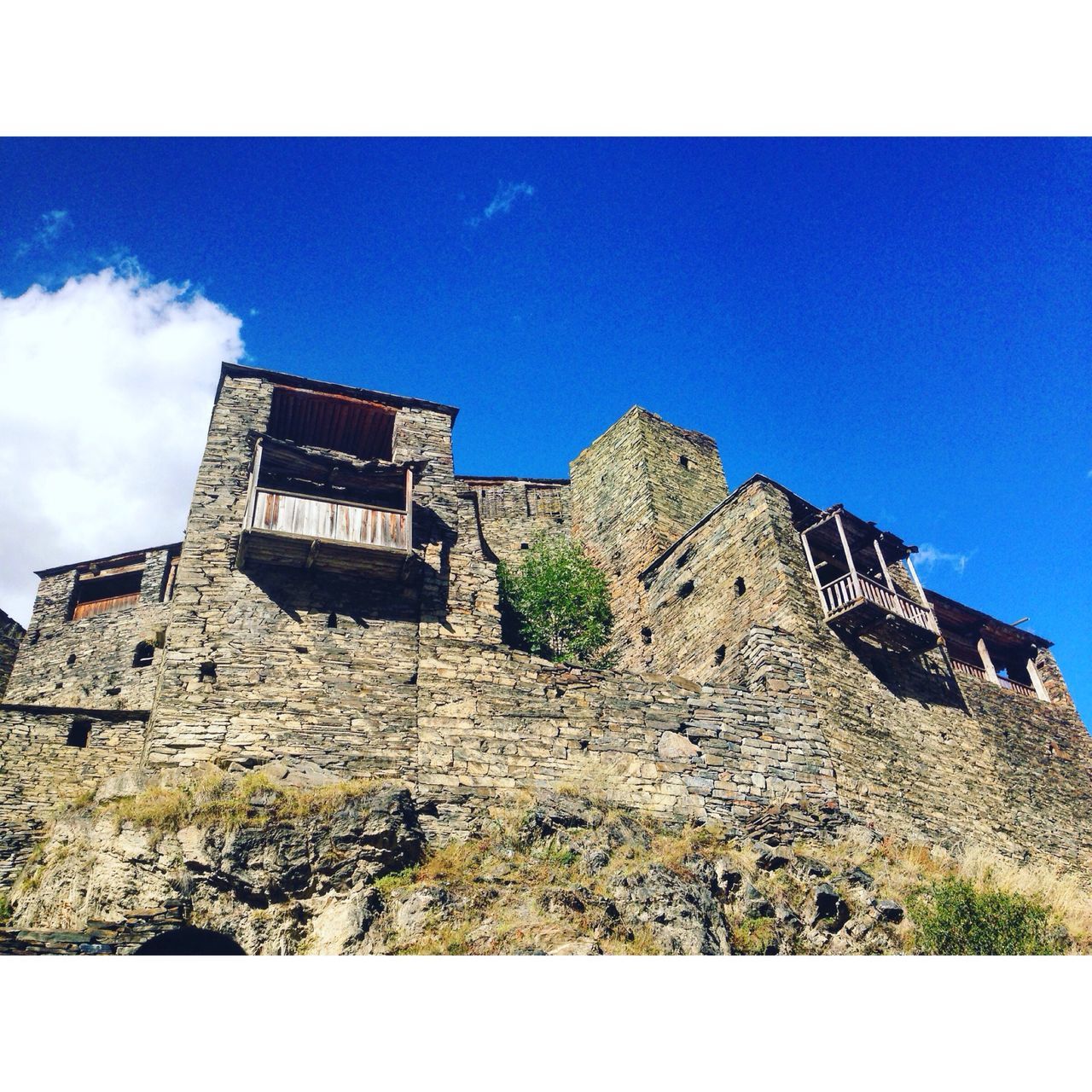 architecture, blue, built structure, low angle view, building exterior, clear sky, copy space, damaged, sky, deterioration, day, outdoors, high section, no people, tall, weathered