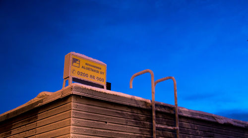 Low angle view of text against clear blue sky