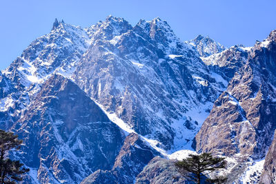 Scenic view of snowcapped mountains during sunny day