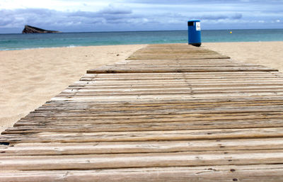 Lifeguard hut on beach against sky