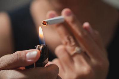 Close-up of hand holding cigarette lighter