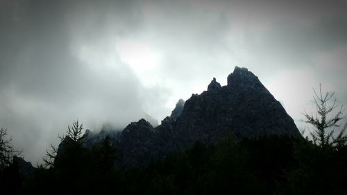 Scenic view of mountains against cloudy sky