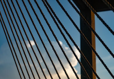 Clouds through the ropes of a hammock