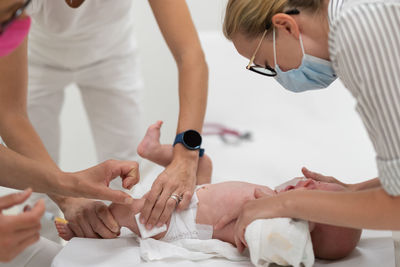 Midsection of doctor examining patient at clinic