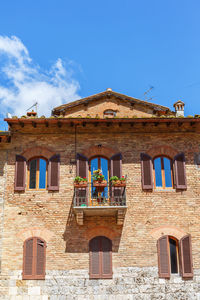 Low angle view of old building against blue sky