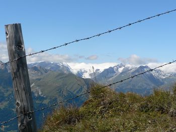 Fence with snowcapped mountain in background