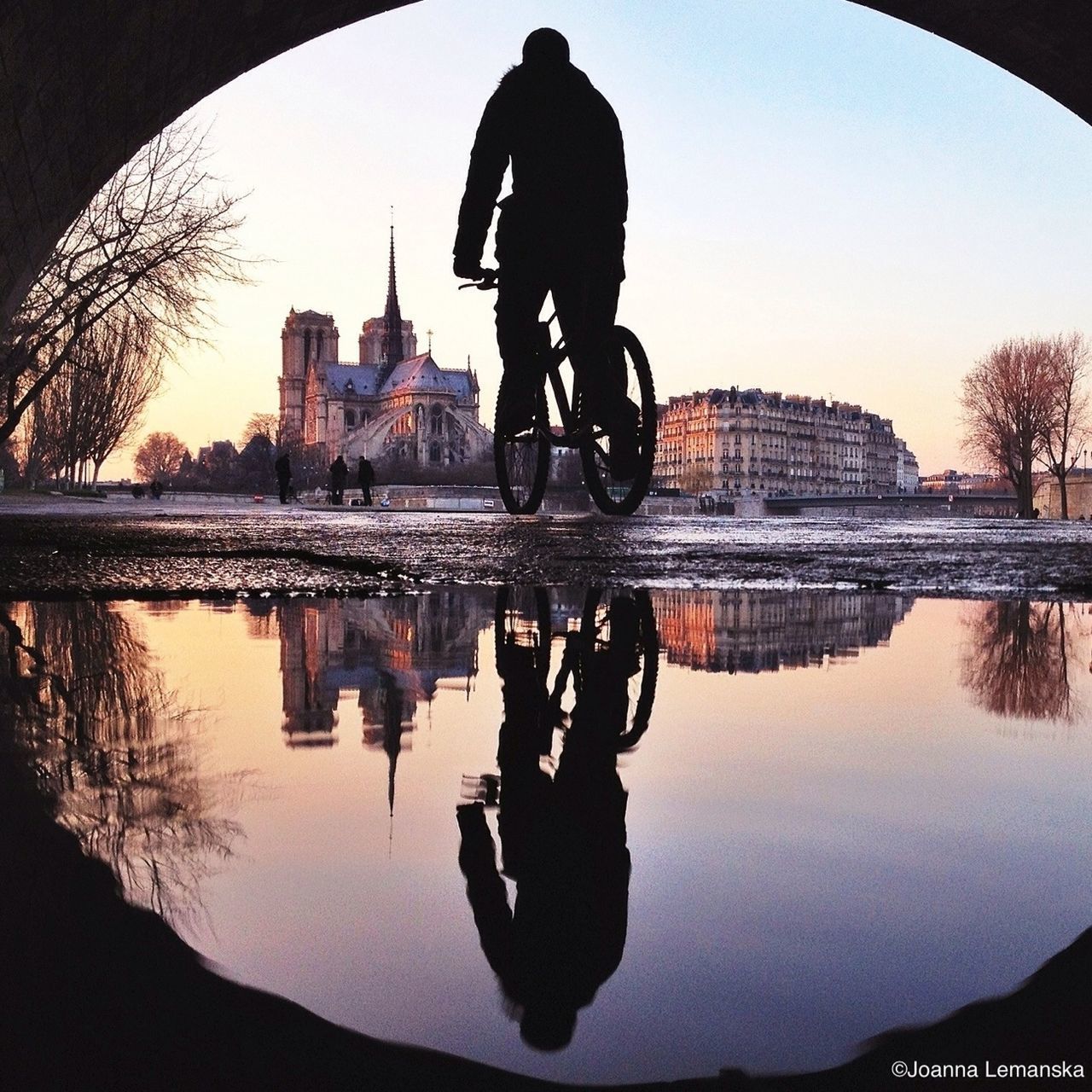 lifestyles, reflection, architecture, built structure, water, leisure activity, full length, men, building exterior, river, standing, clear sky, lake, silhouette, person, rear view, casual clothing