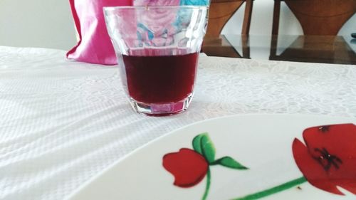 Close-up of red drink on table