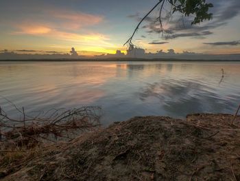 Scenic view of lake against sky at sunset