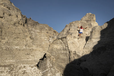 One man descending on a sandy and steep terrain at an old mining area