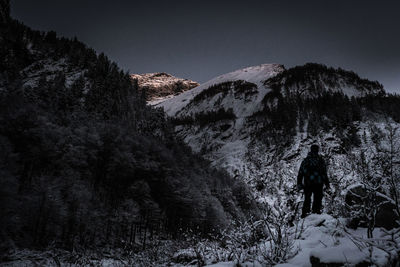 Shadow of man on snowcapped mountain against sky