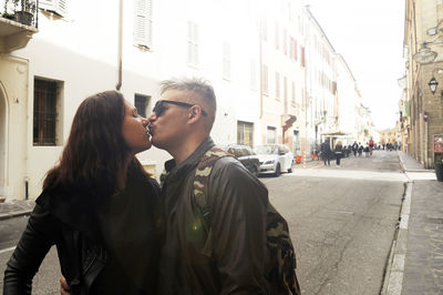 Young couple standing on street in city