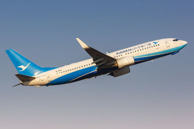 Airplane flying against clear blue sky