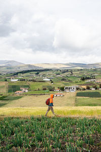 Man on field against sky