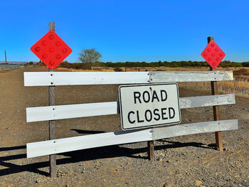 Road sign against blue sky