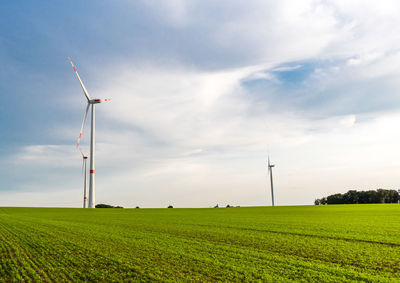 Windmill on field against sky