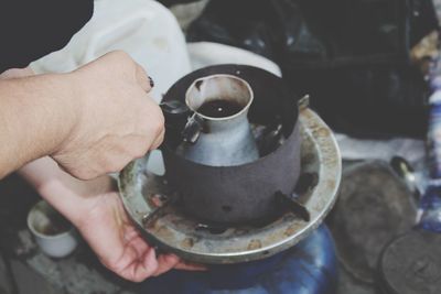 Close-up of person making coffee