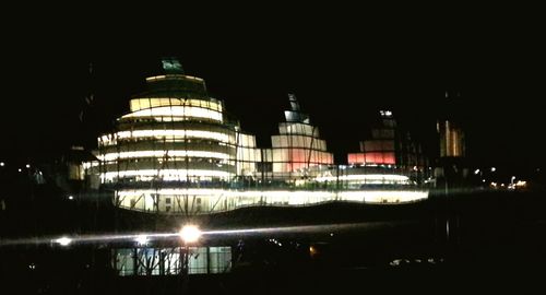 Reflection of illuminated buildings in city at night