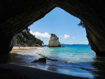 Scenic view of sea seen through cave