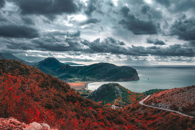 Scenic view of sea and mountains against sky