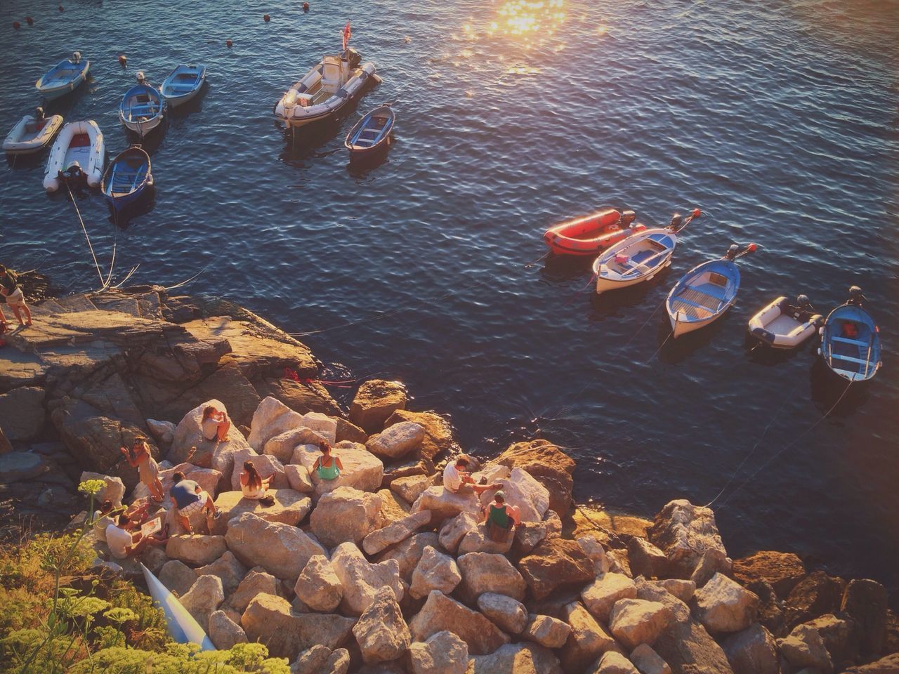 PEOPLE STANDING ON ROCKS