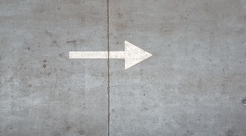 Close-up of arrow symbol on road