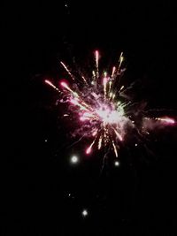 Low angle view of firework display at night