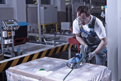 Worker closing freight with foil