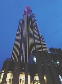 Low angle view of modern building against clear blue sky