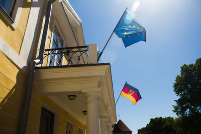 Low angle view of flag flags against sky