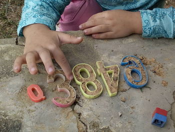 High angle view of girl playing with toy