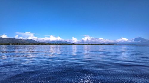 Scenic view of sea against blue sky