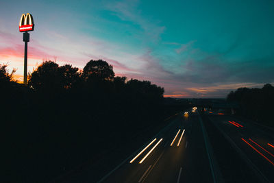 View of traffic on road at sunset