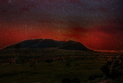 Scenic view of field against sky at night