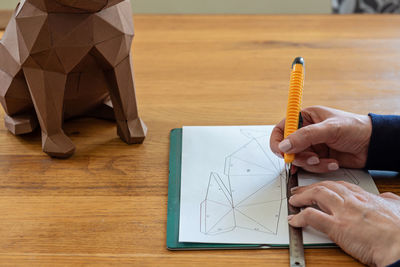 Midsection of man working on table