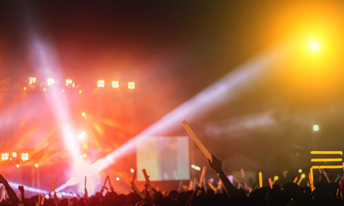 Rear view of people enjoying at music concert