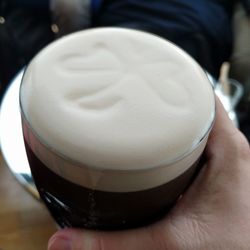 Close-up of hand holding coffee cup