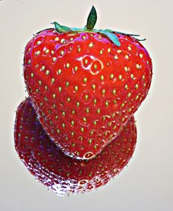 Close-up of strawberry over white background