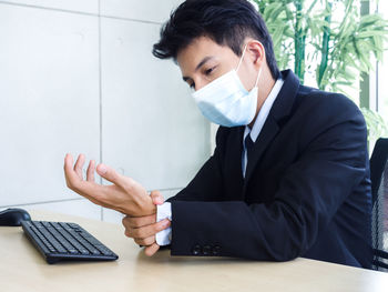 Man using mobile phone on table