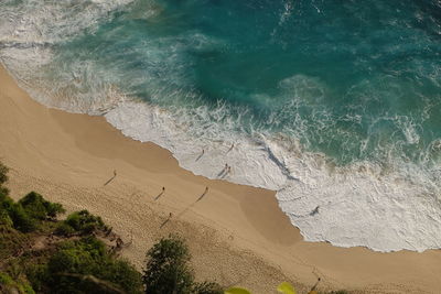 Waves crashing at the beach from above