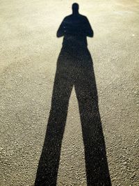 Shadow of man on silhouette person standing in park