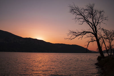 Scenic view of sea against romantic sky at sunset