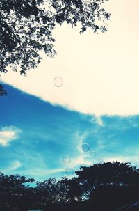 Low angle view of bubbles against sky at dusk