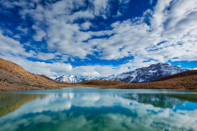 Scenic view of lake and mountains against sky