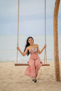 Portrait of smiling young woman on beach