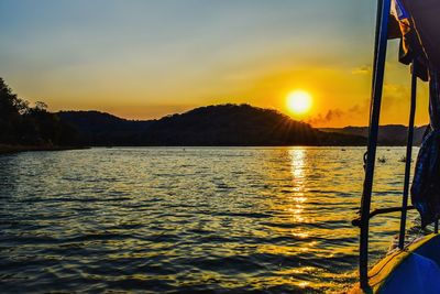 Scenic view of lake against sky during sunset