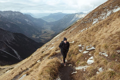 Full length of woman walking on mountain ridge