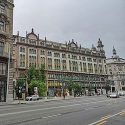 Road by building against sky in city